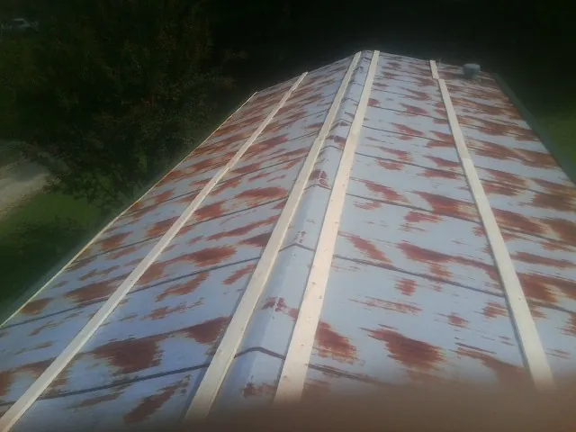 Rusted metal roof panels with new wood purlins before replacement — Storm Damage Roof Repair in Garden Valley by Roofing Brothers
