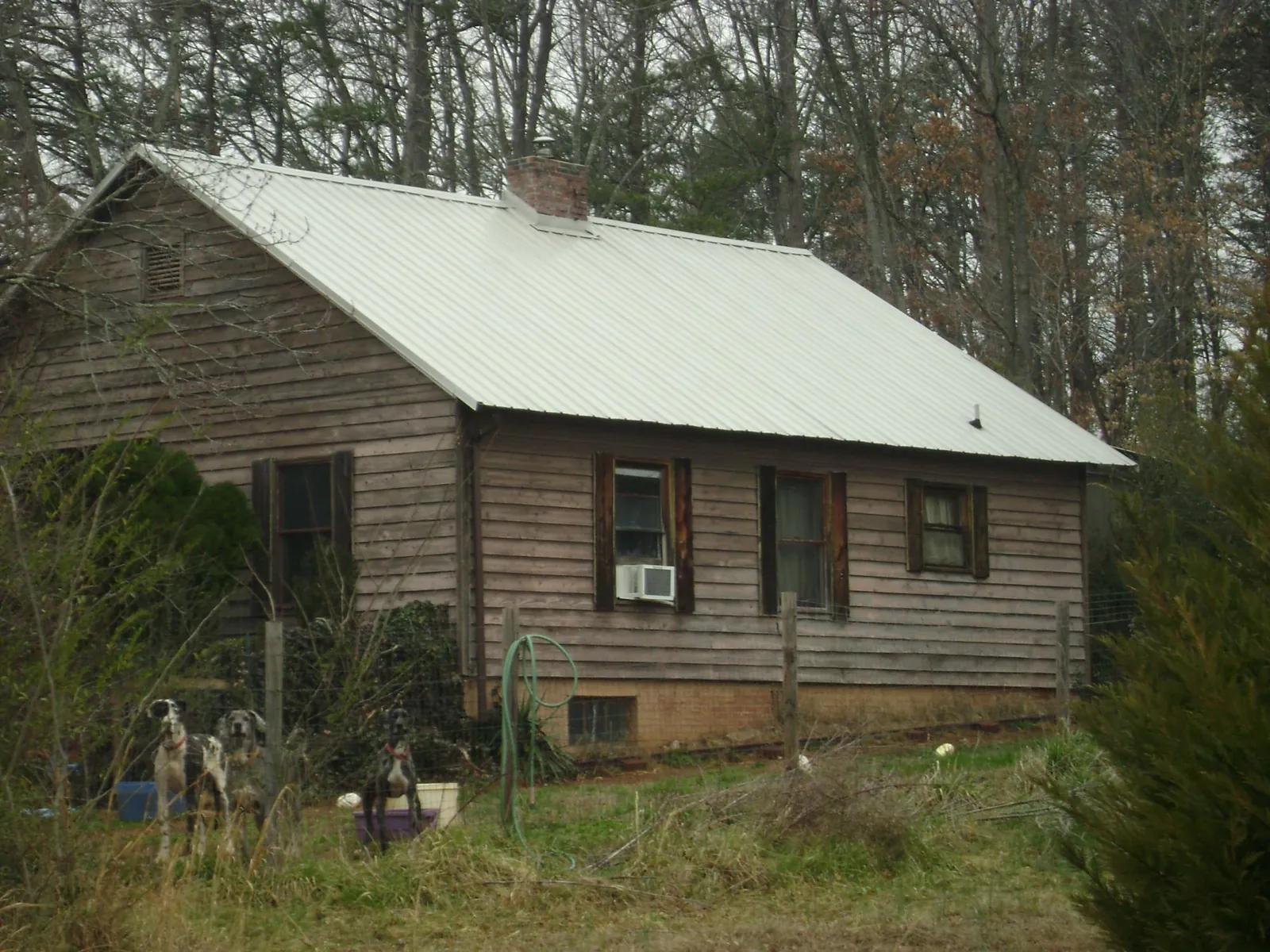 White metal roof on an old wood sided farmhouse, from a Metal Roof Installation job in Garden Valley